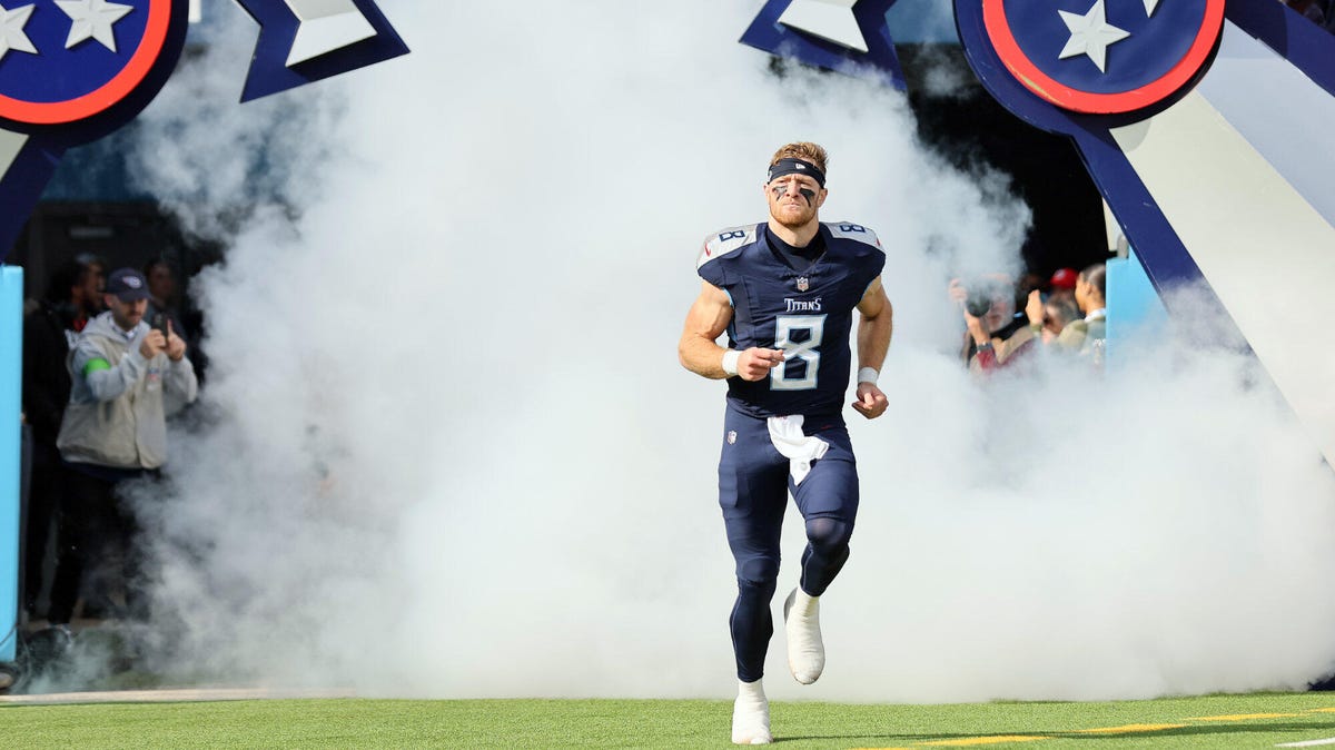 Will Levis of the Tennessee Titans, running out on the pitch towards the camera from a smoke-filled stadium tunnel