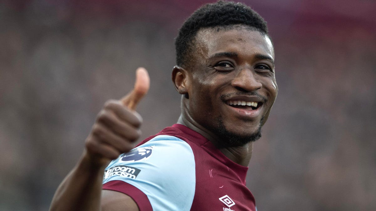 West Ham United forward Mohammed Kudus smiling, looking at the camera whilst giving a thumbs up gesture.