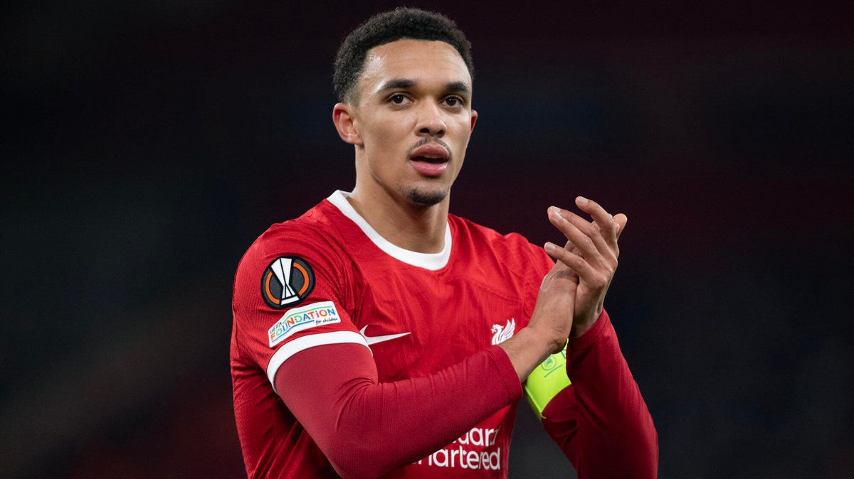 Liverpool defender Trent Alexander-Arnold looking straight ahead while clapping.