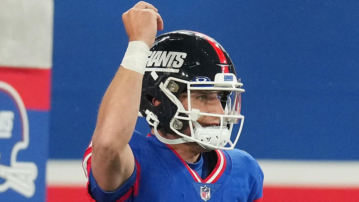 Tommy DeVito of the New York Giants raising his right hand in a fist.