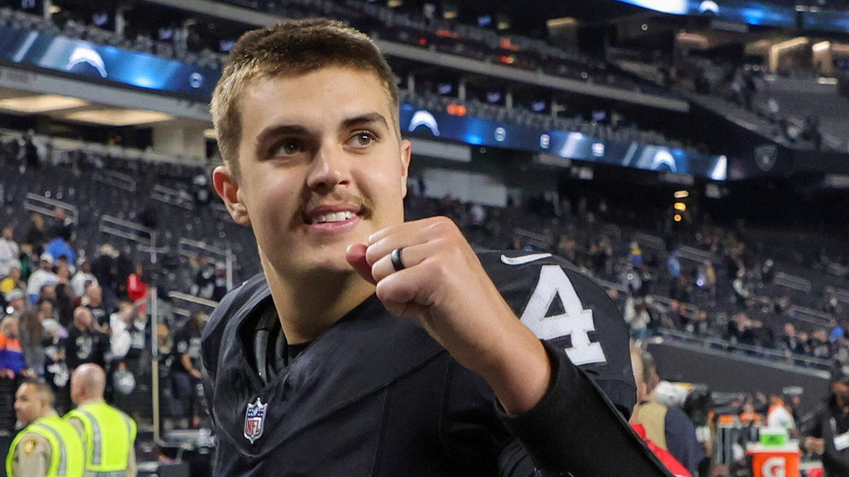 idan O'Connell of the Las Vegas Raiders , smiling and gesturing with a raised left fist.