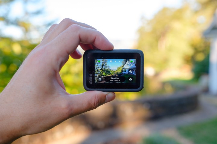 Holding a GoPro Hero9 Black to reveal its on-screen content.