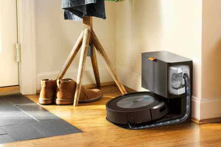 iRobot Roomba j7 plus 7550 robot vacuum in charging dock by entryway.