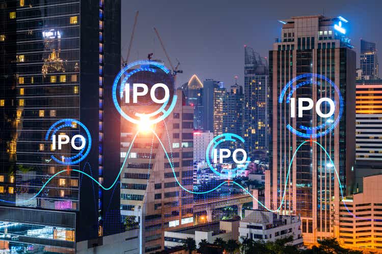 Initial public offering hologram, night panoramic city view of Bangkok. The financial center for multinational corporations in Asia. The concept of boosting the growth by IPO process. Double exposure.