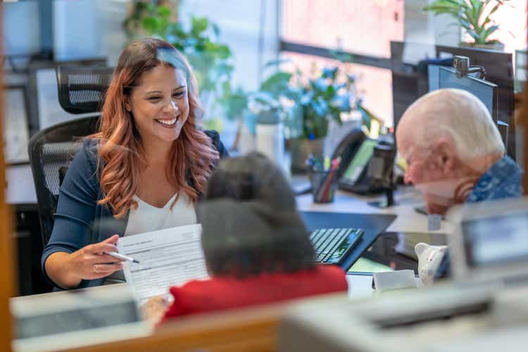 Female businesswoman in meeting with senior couple