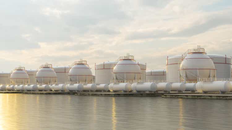 Gas Storage Tanks On Sea Coast At Sunset