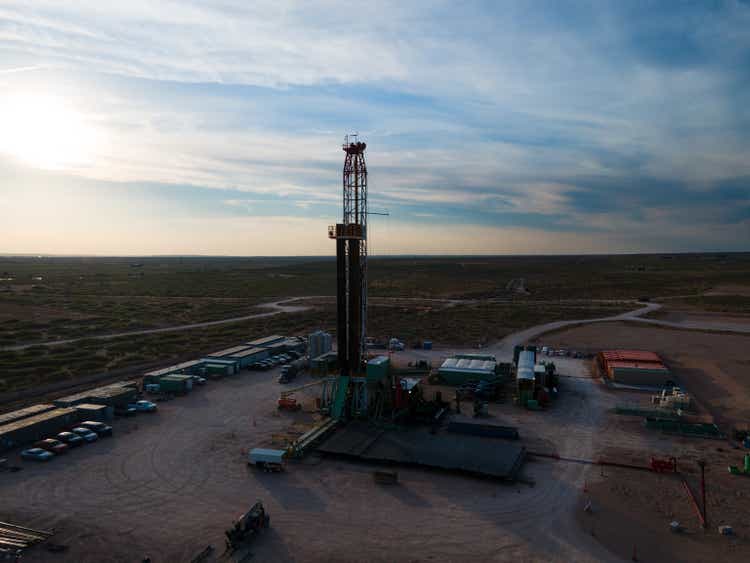 Dusk shot of an oil Fracking Drill Rig Under Dramatic Sunset Sky in the Permian Basin in West Texas or New Mexico