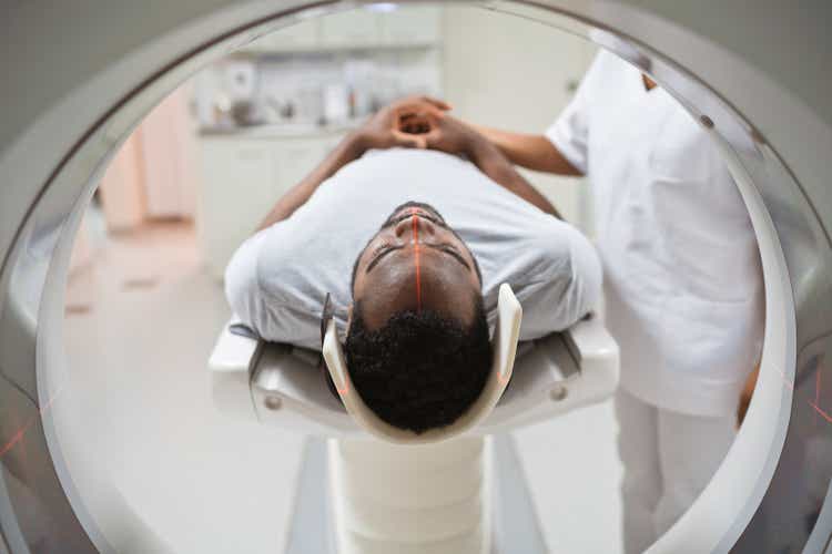 Male patient undergoing MRI scan in medical examination room