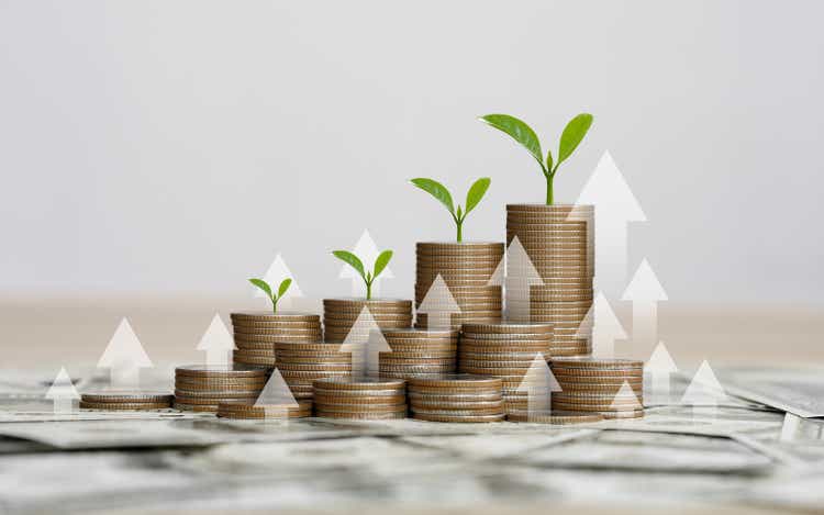 stack of silver coins with the chart in Passive income financial concept and financial investment business stock growth. finance freedom concept.