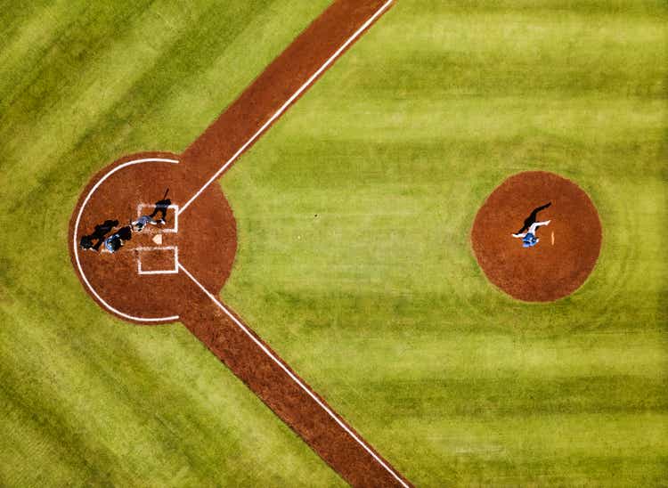 Wide shot pitcher throwing to batter during professional baseball game