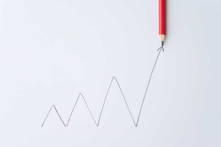 Pencil write chart graph swing growing with arrow trend rise up on white paper background.