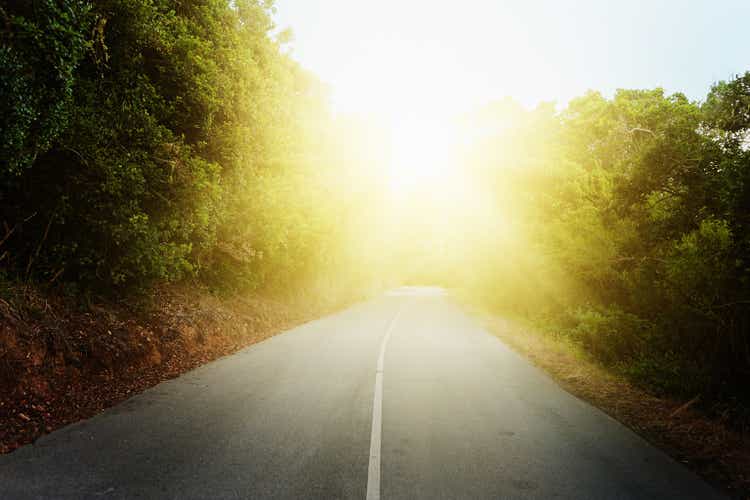 Dazzling sunlight ahead on a country road