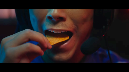 Gamer eating a chip from Doritos