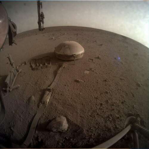 NASA's dust-covered InSight seismometer on Mars' surface.