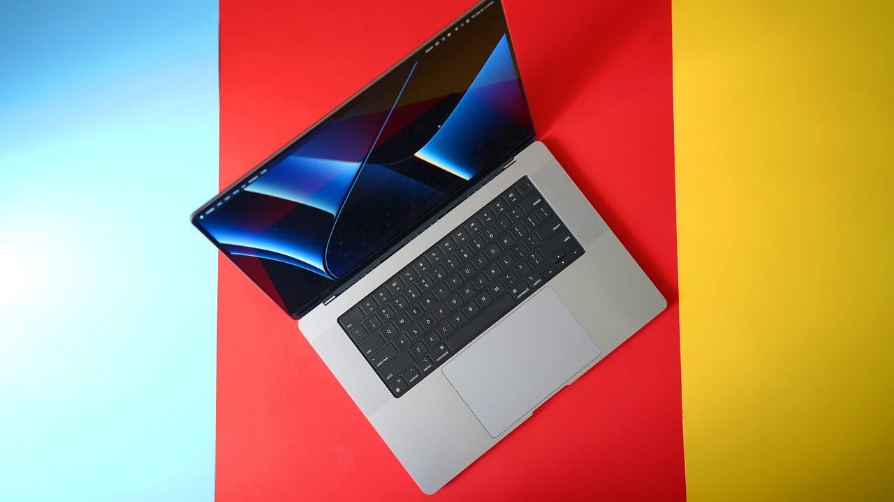 The 16-inch MacBook Pro on a colored tabletop.