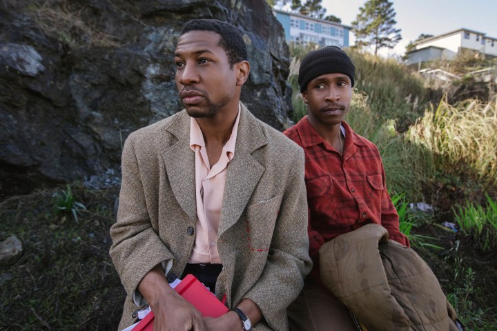 Two men sit down next to each other.