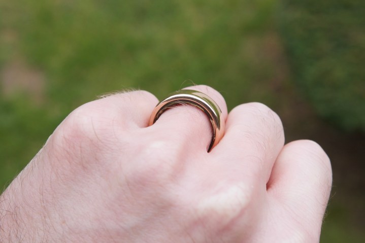 Someone wearing a rose gold Oura Ring.