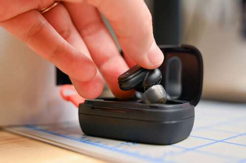 A person putting away a Skullcandy Dime 3 True Wireless Earbud