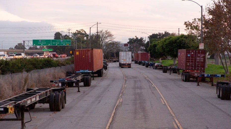 Shipping containers and chassis line a street in Long Beach, California, on Nov. 16, 2021.