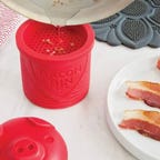 bacon grease being strained into bin