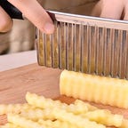 Knife making crinkle cut in potato