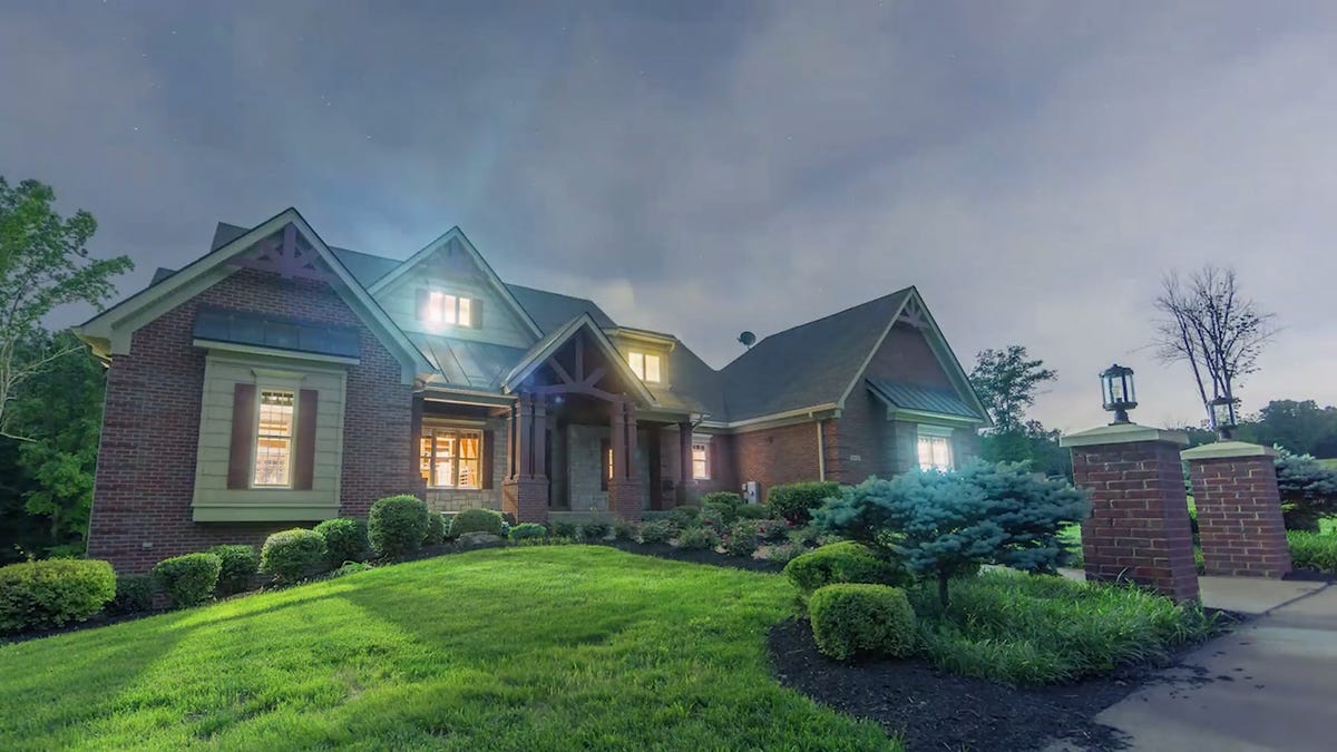 An outside view of the CNET Smart Home at night with lights on.