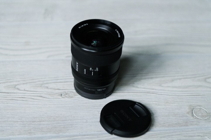 A Sony FE 20mm lens on a surface.