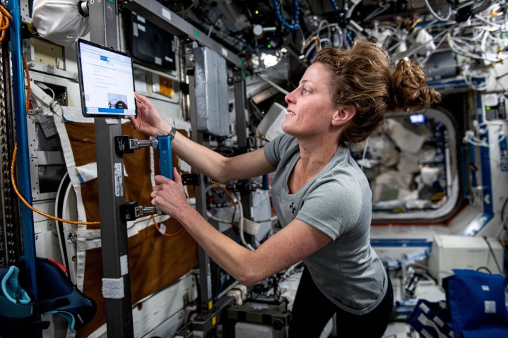 Astronaut Loral O’Hara sets up an exercise cycle.