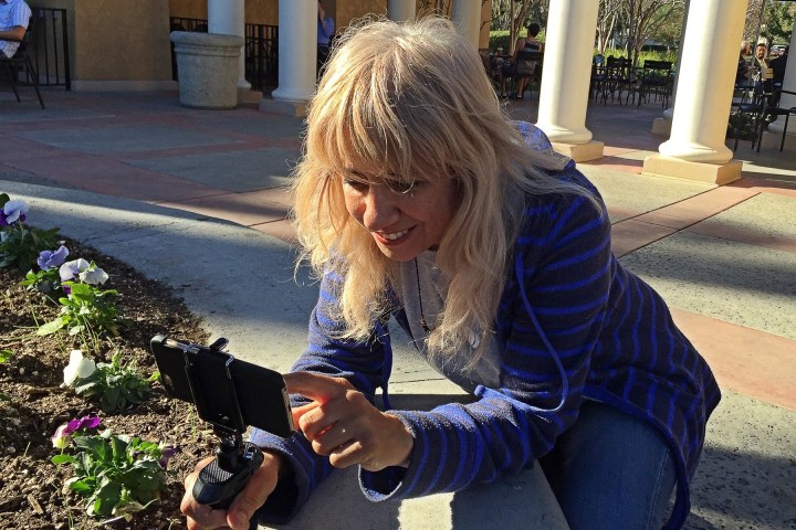 Film director Susy Botello shooting videos on a phone.