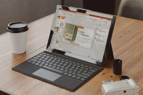 An open laptop with Microsoft PowerPoint on display.