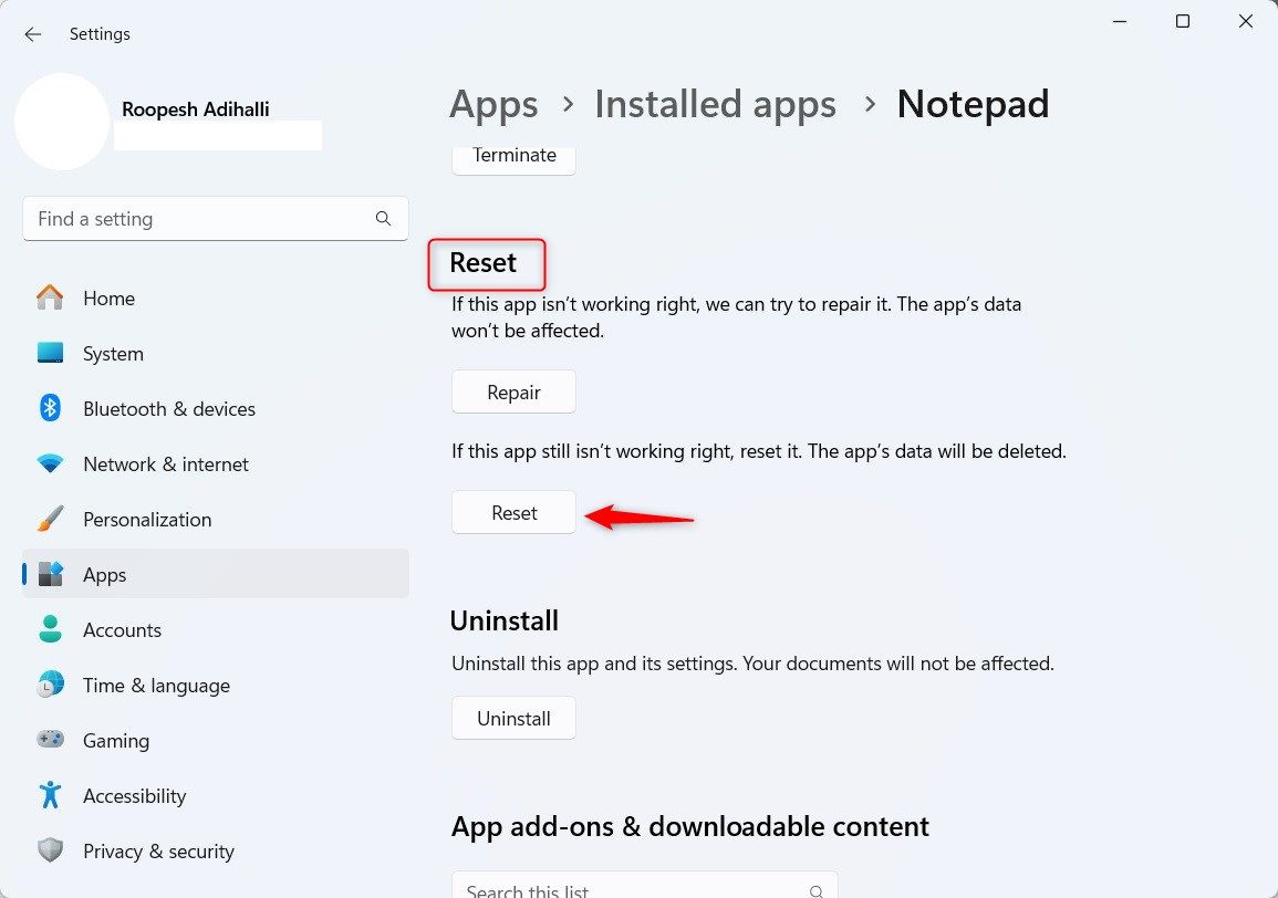 Windows 11 Installed Apps Notepad section highlighting Reset button.