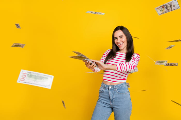 A person throwing cash around.