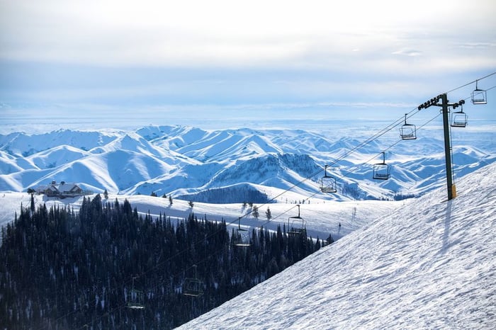 A chairlift going up a ski mountain.