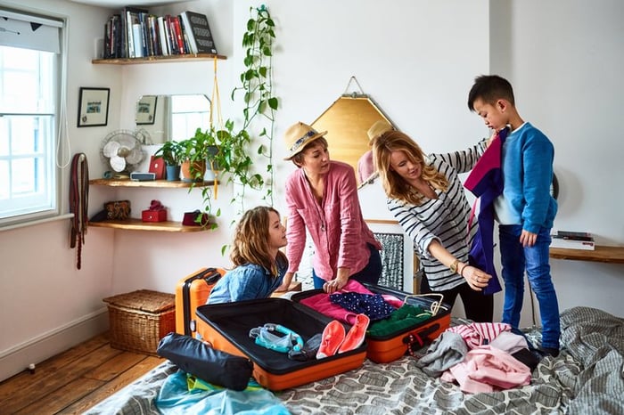 Family with kids packing for vacation.