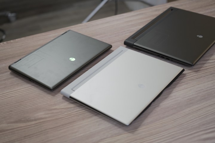 Three Alienware gaming laptops on a table.