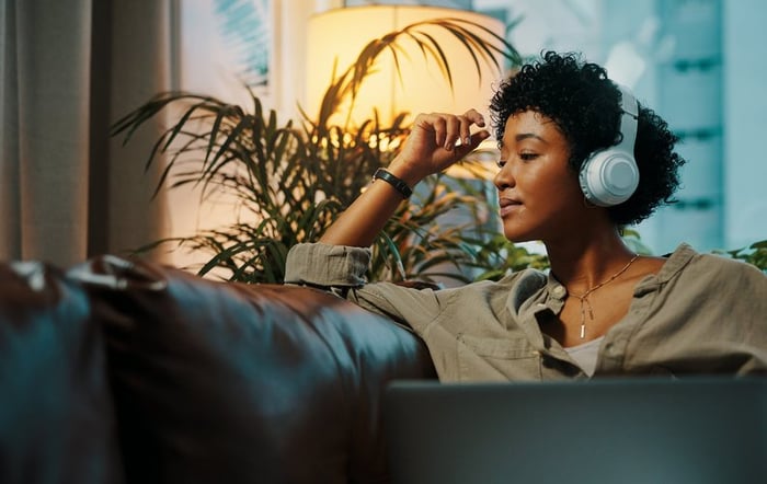 Woman listening to music through headphones.