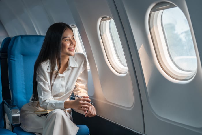 A smiling person on an airplane.