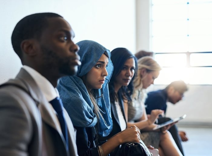 A diverse group of individuals awaiting job interviews.