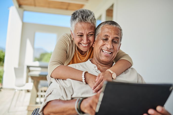 Couple having fun while budgeting.