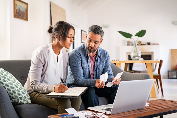 Two adults looking at financial paperwork. 