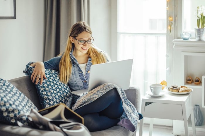 Young woman using laptop on the couch