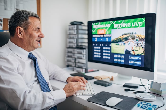 A person placing bets on their computer.