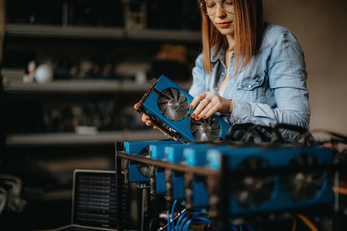 Young person with Bitcoin mining rig.