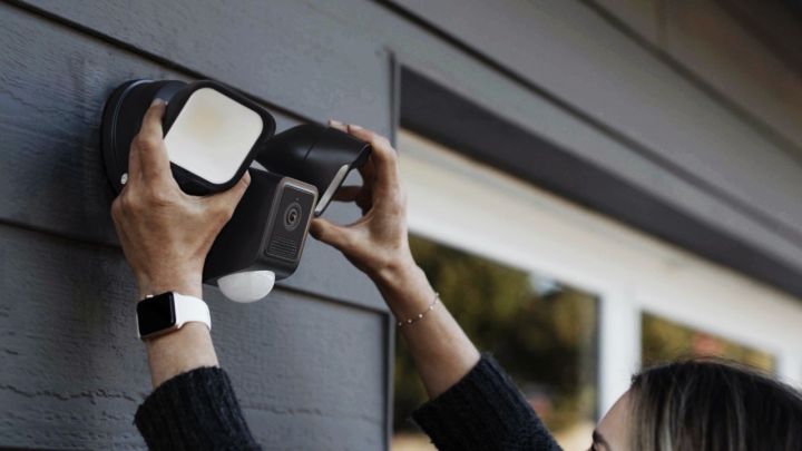 A person adjusting the Wyze Cam Floodlight v2.