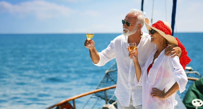 Happy rich couple enjoying a boat ride.