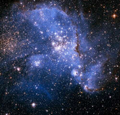 Astronomers have been bemused to find young stars spiralling into the centre of a massive cluster of stars in the Small Magellanic Cloud, a satellite galaxy of the Milky Way. The outer arm of the spiral in this huge, oddly shaped stellar nursery — called NGC 346 — may be feeding star formation in a river-like motion of gas and stars. This is an efficient way to fuel star birth, researchers say.