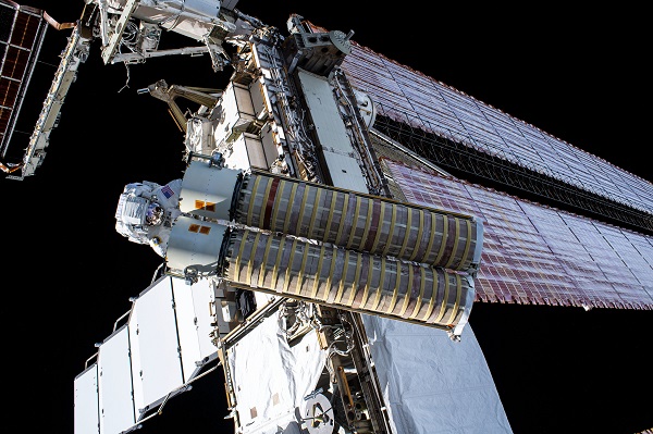 NASA astronaut Shane Kimbrough carries the second ISS roll out solar array (iROSA) toward the space station’s Port-6 truss structure where he and fellow spacewalker Pesquet would install it