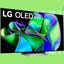 An LG OLED TV against a green background.