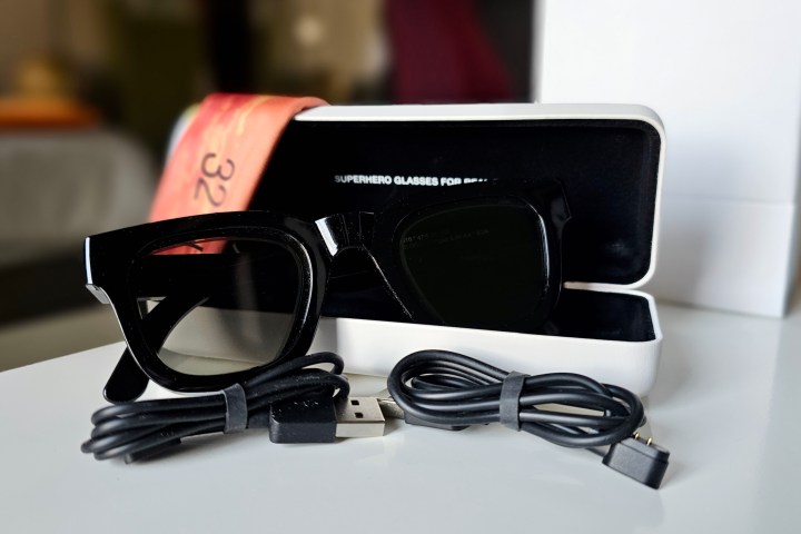 Deep Optics 32°N Sunglasses with case, two charging cables, and a cleaning cloth.