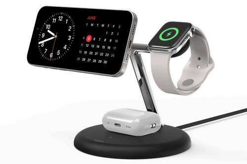 An iPhone, Apple Watch, and AirPods charging on the Belkin BoostCharge Pro 3-in-2 stand. The iPhone is turned into landscape mode for StandBy mode.